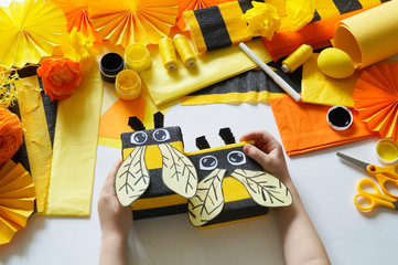 The child loves crafts bee. The child's hands. Gift packing. Materials for creativity.