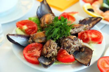 Mussels with tomatoes on the restaurant table 