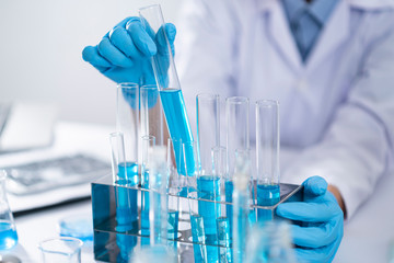 Researchers are using glassware and blue solutions in laboratories, research on cosmetics and energy.