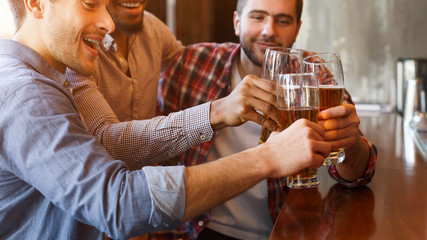 Cheers, Friends. Men Drinking Beer And Clinking Glasses