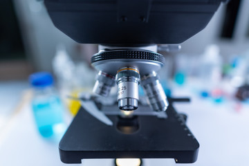 Close-up shot of microscope with metal lens at laboratory.
