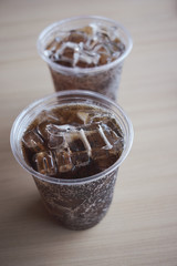Beverage from cola in glass and a can of sparkling water with ice cube,beverage in summer is sparkling water.