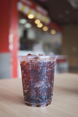 Beverage from cola in glass and a can of sparkling water with ice cube,beverage in summer is sparkling water.