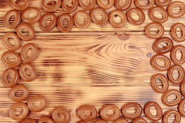 Heap of bagels scattered on the wooden table with copy space