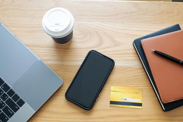 Using a credit card to pay online, use a smartphone for online shopping, a male hand holds a credit card.