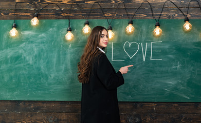Students love. Portrait of girl teenager in love. Young cute teenage girl in classroom at...