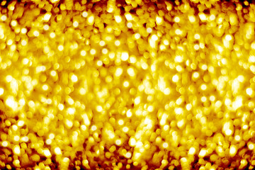 Golden blurred shining bokeh background, defocused yellow sparkles backdrop, gold color shiny round bubbles blur effect, festive New Year and Christmas banner design, holiday frame, copy space