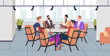 businesspeople group discussing new project during conference meeting sitting at round table brainstorming colleagues planning startup business time concept modern co-working office interior full