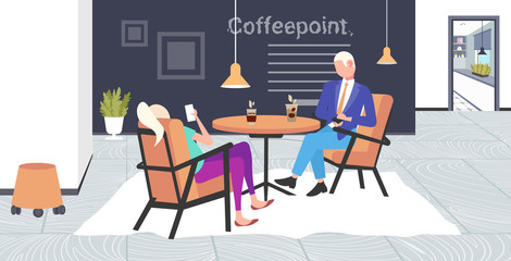 businesspeople using smartphones during corporate break business man woman coworkers sitting cafe table coffee point interior flat full length horizontal