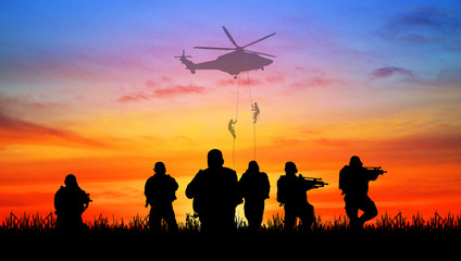Fototapeta na wymiar Silhouette of soldier battlefield on a sunset