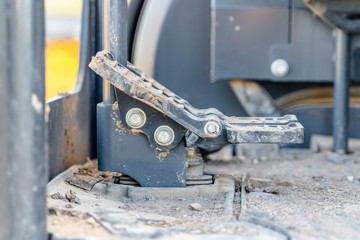 Foot controls and floor of a construction machinery covered in dirt