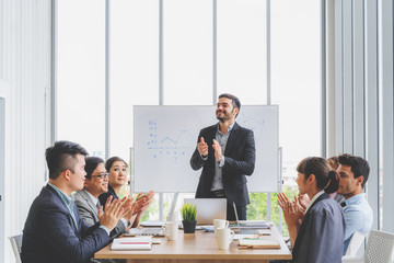 Businesspeople discussing together in conference room during meeting at office.