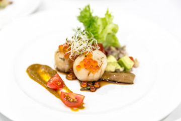 Delicious appetizer scallops with caviar.  plate fine dining restaurant