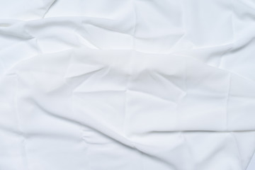 White wrinkled, rippled, surface fabric texture background.