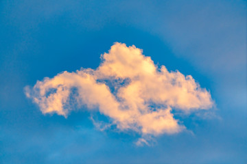 Cottony white clouds isolated against a vivid blue sky background