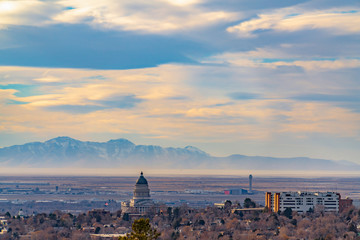 Panorama of downtown Salt Lake City against majestic mountain and cloudy sky