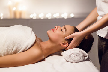 Obraz na płótnie Canvas Relaxing Massage. Woman Enjoying Head Massage At Spa