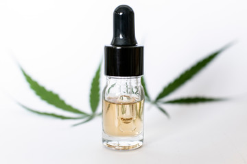 Fototapeta premium Medicinal cannabis with oil in a bottle on white background.