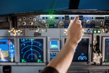 man hand operate switch on airplane panel