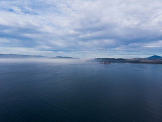 Beautiful drone picture of ocean and fog