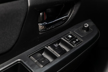 Interior design of the modern car: window adjustment buttons, door lock. luxury prestige car interior.