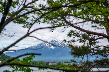 Beautiful Fuji Mountain, Fujisan volcano at Kawaguchiko lake, Japan. Blue sky high peak mountains fog hills mist scenery river lake 