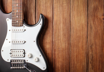 Fototapeta na wymiar electric guitar on a wooden background