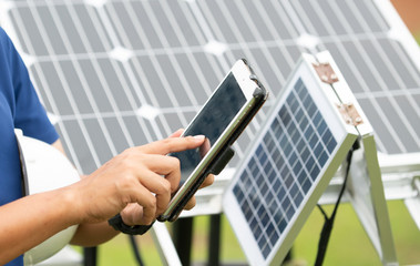 Engineer with tablet computer on a background of photovoltaic panels.