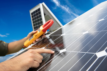 An engineer working on checking equipment in automatic solar tracker.