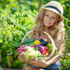 Child with vegetables in nature 