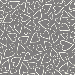 Hand drawn white and grey outlined hearts in a tossed pattern. A pretty vector seamless repeat pattern ideal for valentines fabric, scrap booking and stationery projects projects.