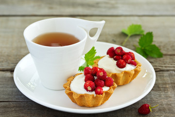 Wild strawberry tartlets with cream filling. delicious summer fruit mini tarts
