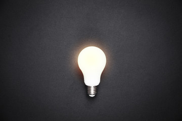 Glowing light bulb in the black background.