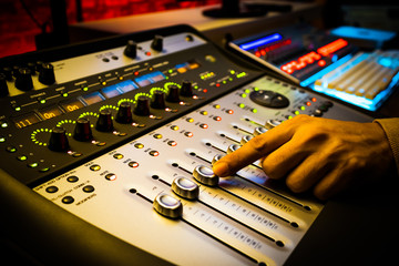 sound engineer, producer hand working on professional recording, broadcasting studio equipment