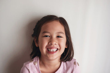 Portrait of happy Asian young little girl smiling