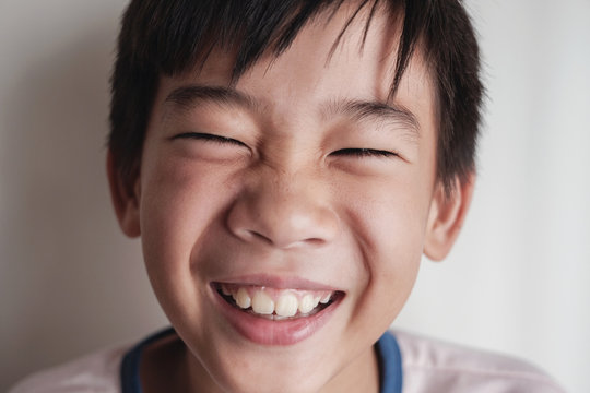 Portrait Of Happy Asian Tween Preteen Boy Laughing