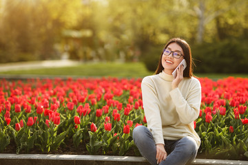 Student Girl Resting In Park And Talking On Phone