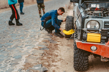 A man pumps air wheel with a compressor © teksomolika