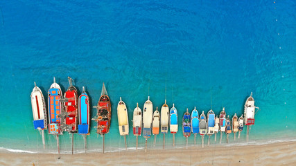 Boats in the sea, top view. Aerial view of colorful boats standing abreast on the shores of the...