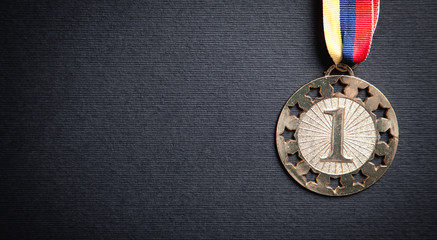 Medal awards for winner on black background.