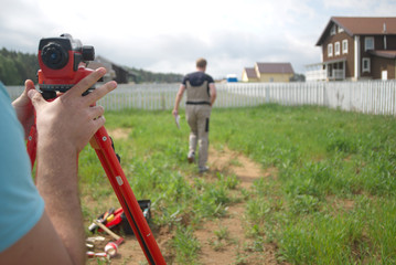 Two surveyors measuring land