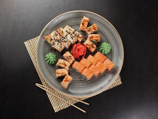 Fresh and delicious sushi set on black table