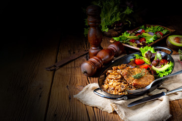 Pork steak with mushrooms and buckwheat groats and mango salad