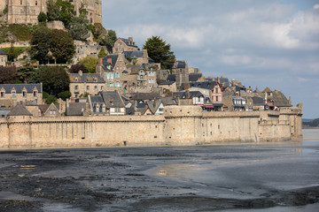 Fototapeta premium Le Mont Saint-Michel, medieval fortified abbey and village on a tidal island in the Normandy, France, at low tide