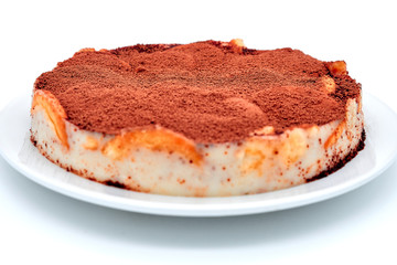 Chocolate cookie cake on isolated white background. Chocolate cream pastry, isolate background. Pie sprinkled with cocoa powder on a plate.