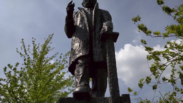 Statue of politician P.J. Troelstra next to old Church Tower Oldehove Leeuwarden Time Lapse, Spring, Sunny clouds.