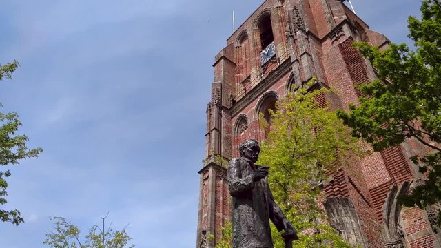 Old Church Tower Oldehove Leeuwarden Time Lapse, Spring, Sunny clouds. In front is the statue of Mr. P.J. Troelstra