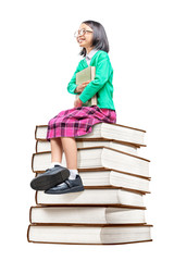 Asian cute girl with glasses holding the book while sitting on the pile of books