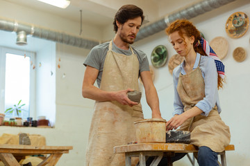 Concentrated professional couple working in equipped studio