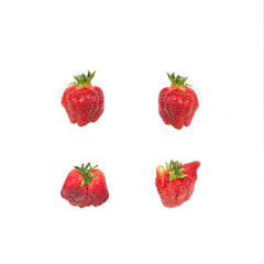 Group of imperfect strawberries isolated on white background.